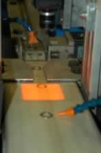Deficient rings are blown off the conveyor.